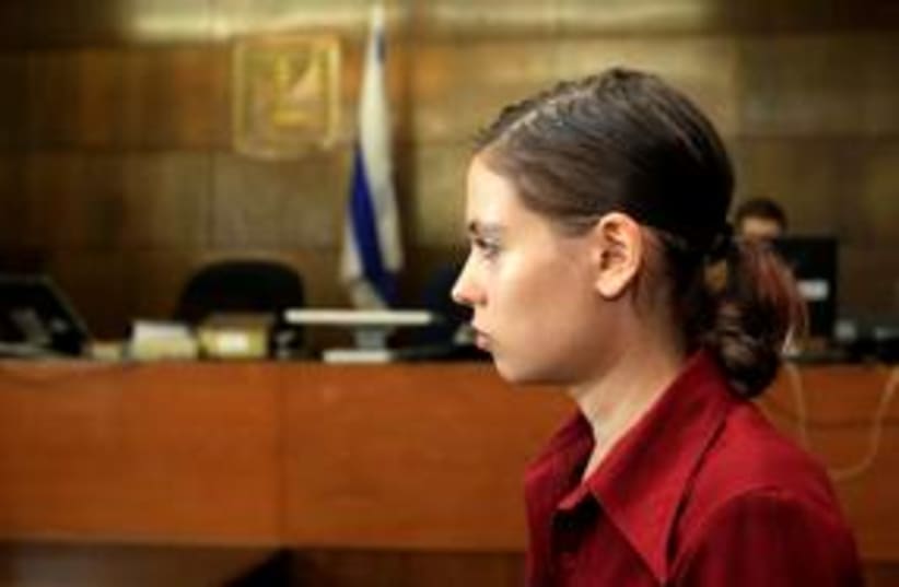 Anat Kamm stands inside a courtroom in Tel Aviv 311 (R) (photo credit: REUTERS/Ronen Zvulun)