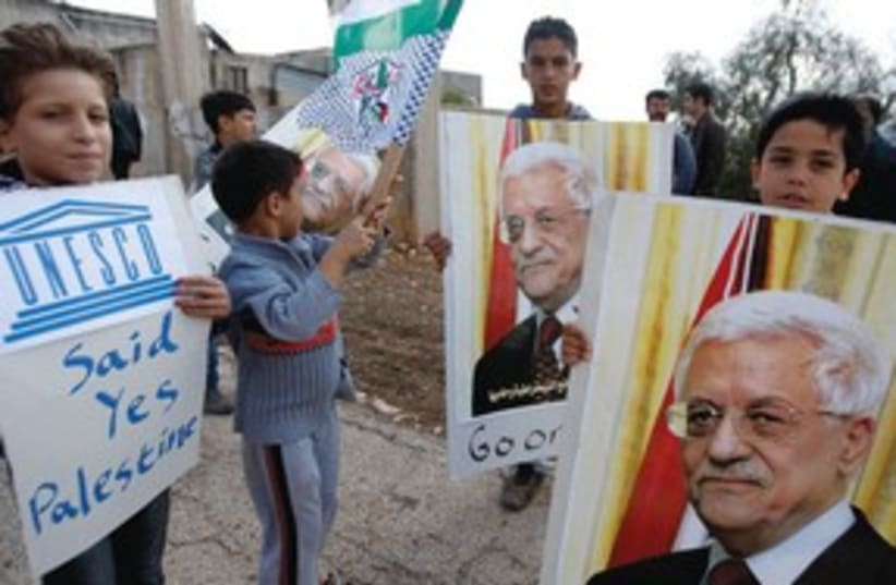 Kids with posters of PA President Mahmoud Abbas 311 (R) (photo credit: Abed Omar Qusini/Reuters)