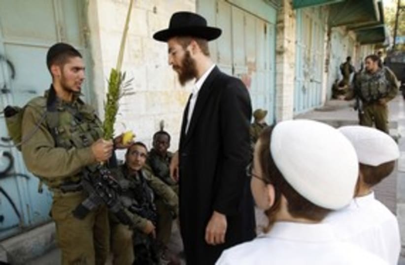 IDF soldier, religious Jews on sukkot, Hebron_311 (photo credit: The Jewish Community of Hebron)