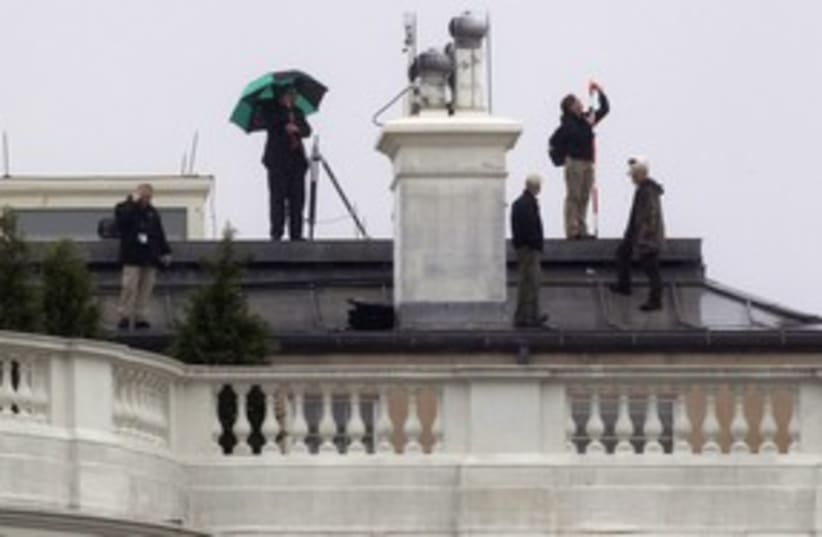 Crew atop White House where bullets hit 311 R (photo credit: 	 REUTERS/Kevin Lamarque)