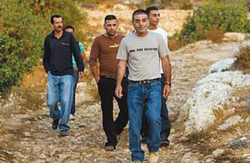 Palestinians walk in the West Bank 311 (photo credit: REUTERS)