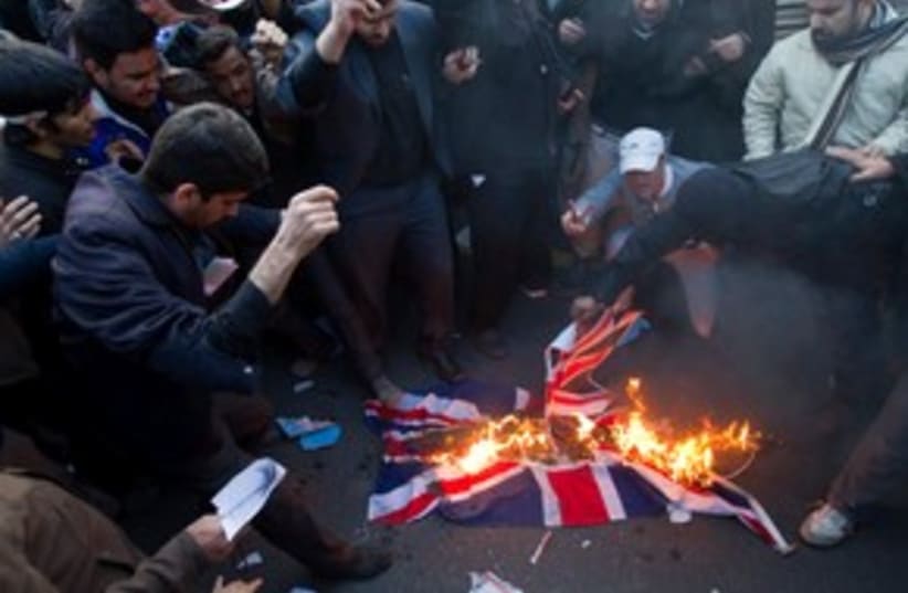 Iranian demonstrators carry a British flag (R) 311 (photo credit: 	 REUTERS/Raheb Homavandi)