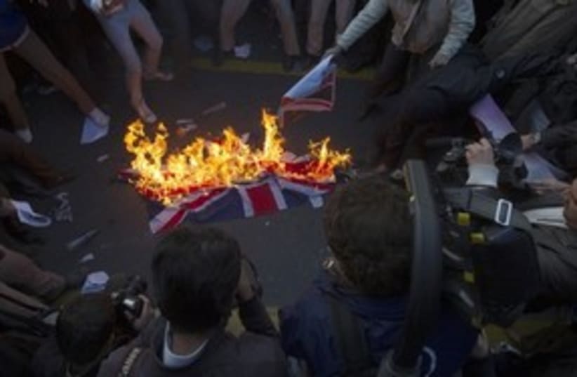 Iranian demonstrators burn British flag 311 R (photo credit: Reuters)