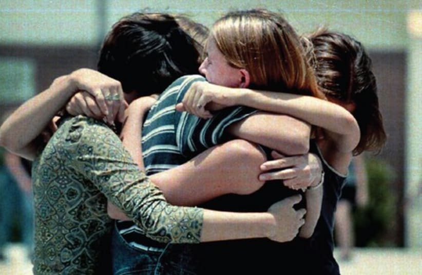 Girls hugging 521 (photo credit: MCT)