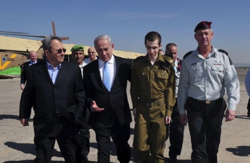 Gilad Shalit returns from captivity, alongside Ehud Barak, Benjamin Netanyahu, and Benny Gantz. (photo credit: REUTERS/Handout .)