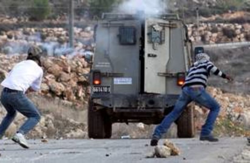 Mustafa Tamimi being shot with tear gas in Nebi Salah 311 (photo credit: REUTERS/Haim Schwartzenberg)