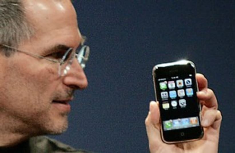 Steve jobs (with iphone) 311 (photo credit: Reuters)