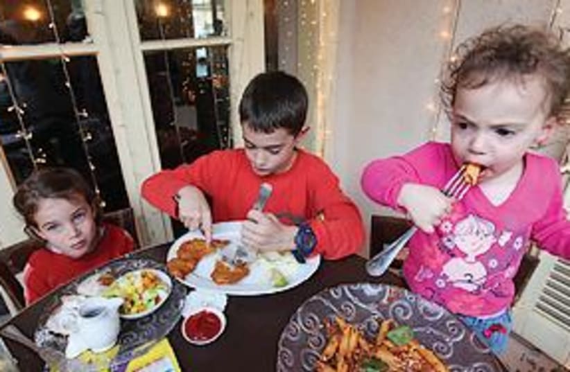 Children eating 311 (photo credit: Dudu Azoulay)