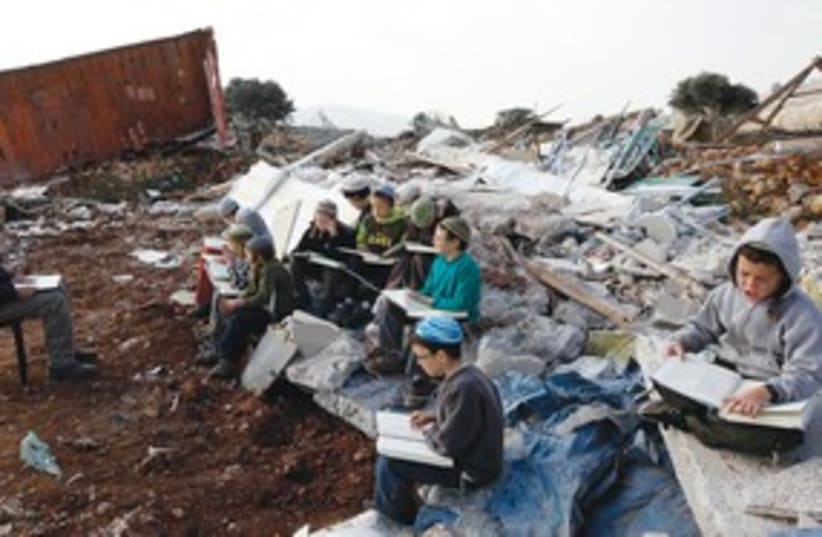 boy studies near destroyed home, Mitzpe Yitzhar_311 (photo credit: Reuters)