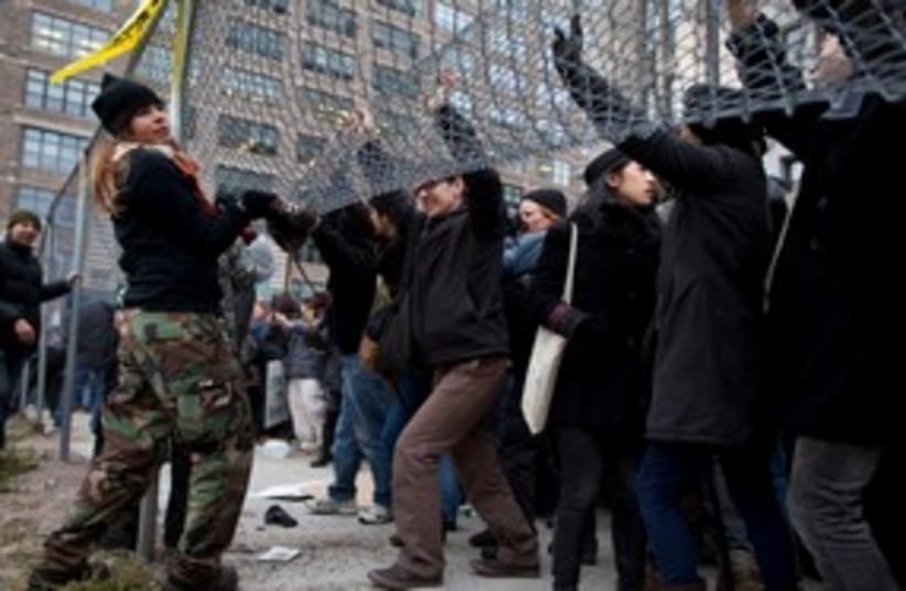 Occupy protesters lift fence in NY 311 (photo credit: REUTERS)