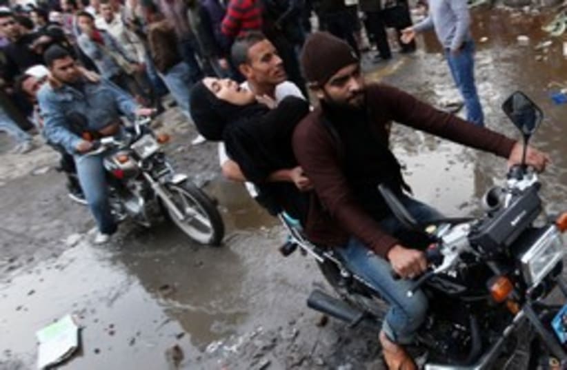 Egyptian protesters evacuate injured 311 (photo credit: Reuters)