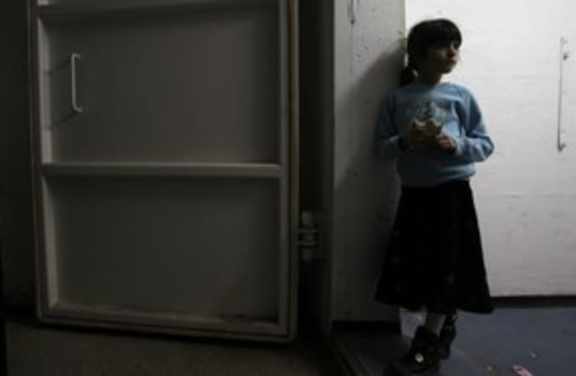 A girl stands inside a bomb shelter in Ashkelon 311 (R) (photo credit: Ronen Zvulun / Reuters)