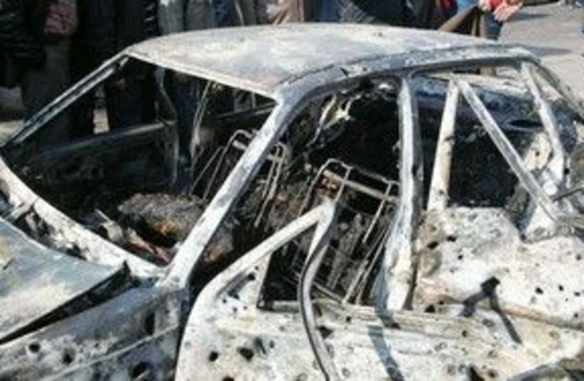 A damage car at the scene of bombings in Damascus 311 (R) (photo credit: REUTERS/ Sana/Handout )