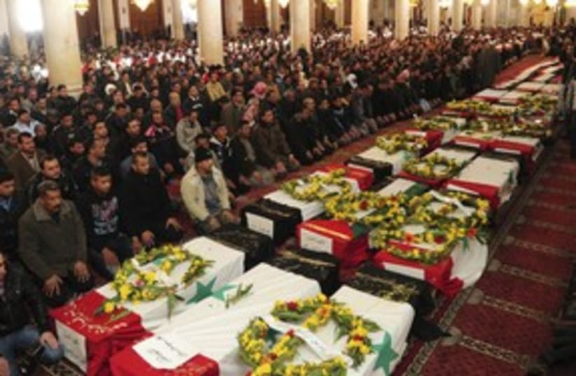 Syrians pray next to coffins 311  (photo credit:  REUTERS/Sana Sana)