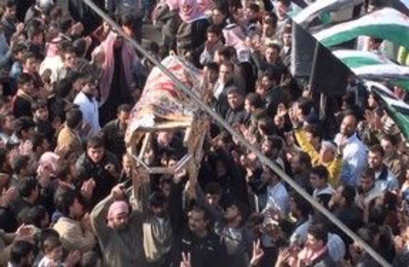 Protesters carry a coffin near Homs, Syria 311 (R) (photo credit: REUTERS/Handout)