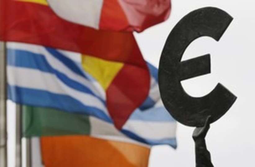 Euro symbol near European flags 311 (photo credit: REUTERS/Francois Lenoir)