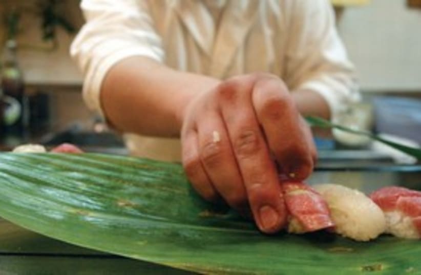 sushi chef prepares sushi_311 (photo credit: Reuters)