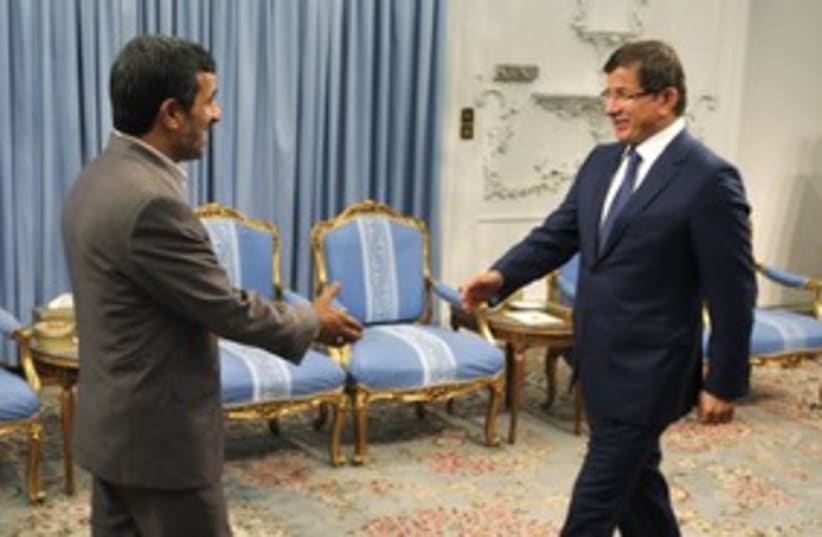 Iranian President Ahmadinejad, Turkish FM Davutoglu (R)_311 (photo credit: Reuters)
