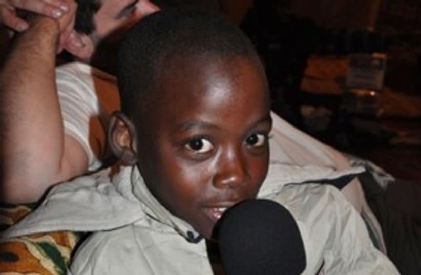 Malian child holding Campos' IDC microphone 311 (photo credit: daniel campos)