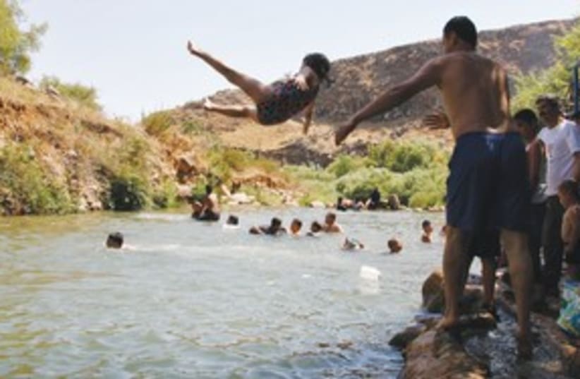 Lebanese villagers play in water 311 (photo credit: REUTERS)