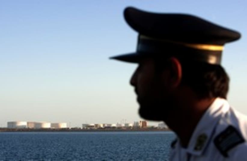 Iranian officer looks at Strait of Hormuz 311 (R) (photo credit: REUTERS/Raheb Homavandi)