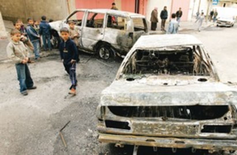 Palestinians near damaged cars 311 (photo credit: REUTERS)