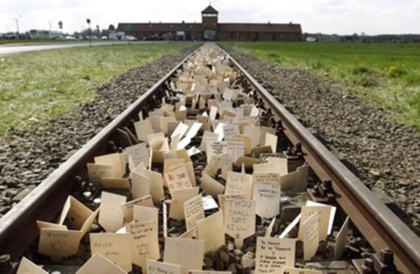 Placards placed on railway to Birkenau 390 (photo credit: REUTERS)