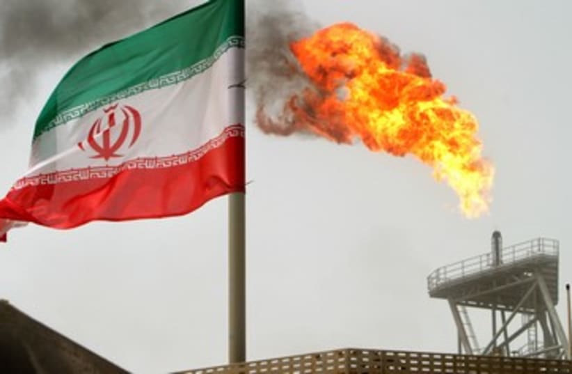 Iranian oil platform, Iran flag (photo credit: Reuters)