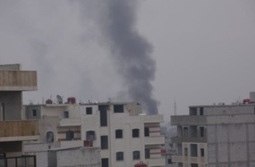 Smoke rising from suburb in Damascus 390 (photo credit: REUTERS)