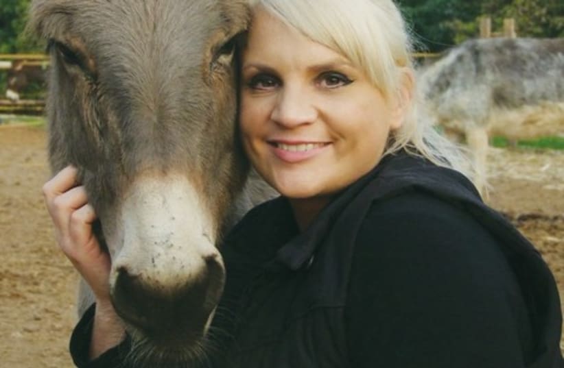 Lucey Fensom with donkey animal 521 (photo credit: Tova Saul)