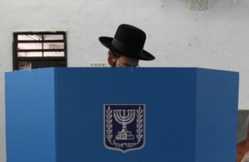 Haredi man casts ballot elections 390 (R) (photo credit: Gil Cohen Magen / Reuters)