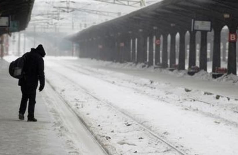 Man walks through empty rail station in Bucharest 390 (R) (photo credit: REUTERS/Bogdan Cristel)