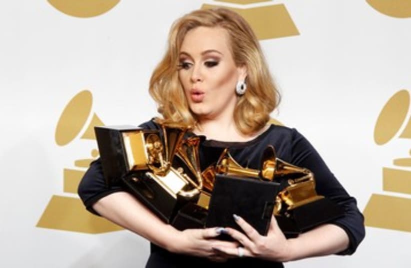 Singer Adele holds her grammy awards 390 (photo credit: REUTERS/Lucy Nicholson)