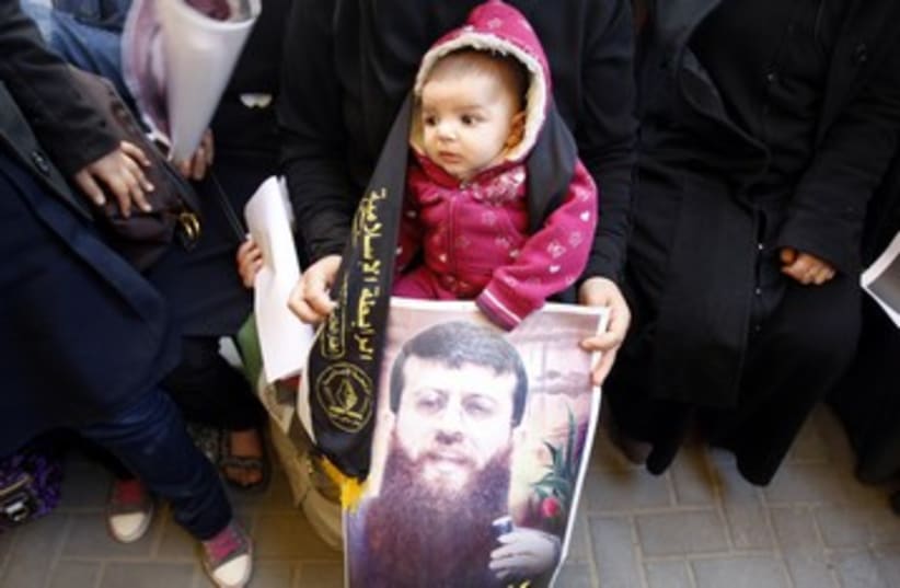 Child holds picture of Khader Adnan 390 (photo credit: )