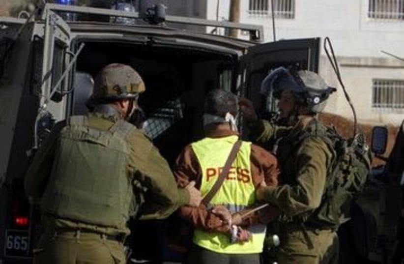 IDF soldiers detain a journalist in Nabi Saleh 390 (R) (photo credit: Mohamad Torokman / Reuters)