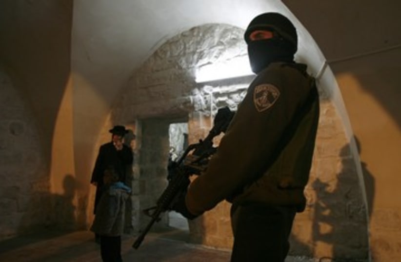 IDF soldier stands guard at Joseph's Tomb 390 (photo credit: REUTERS)