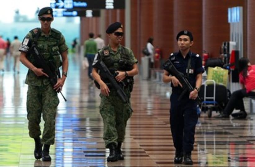 Singapore soldiers patrolling 390 (photo credit: REUTERS/Vivek Prakash)
