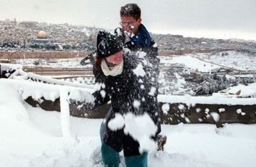 Couple playing in Jerusalem snow 390 (photo credit: REUTERS)