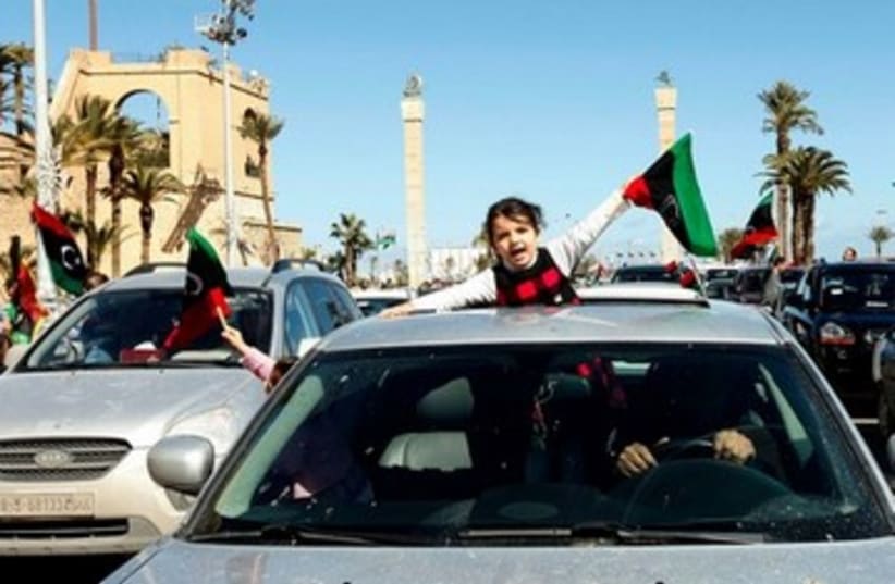 Girl waves a Libyan independence flag 390  (photo credit: REUTERS)