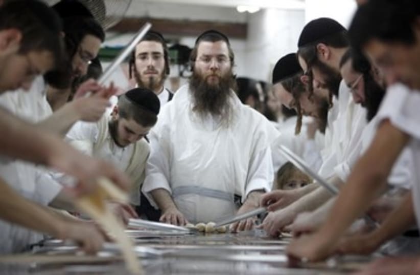 Orthodox men prepare matza 390 (R) (photo credit: NIR ELIAS / Reuters)