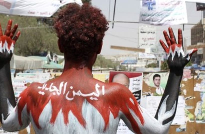 demonstrator paints his body in Yemen colors_390 (photo credit: Reuters)