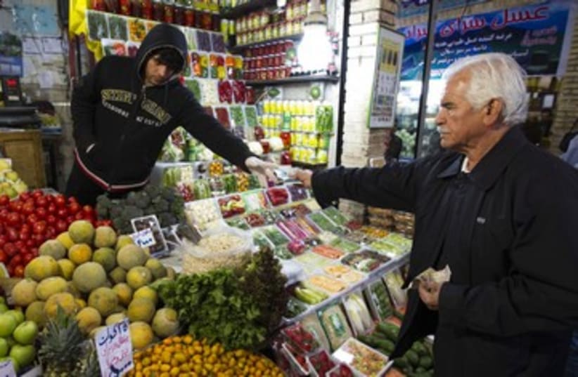 Iranian man shops in a bazar in Tehran  R 390 (photo credit: REUTERS)