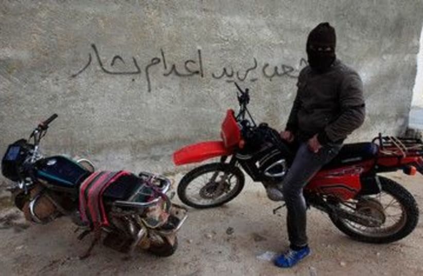 Free Syrian Army member on a motorcycle 390 (R) (photo credit: REUTERS/Zohra Bensemra)
