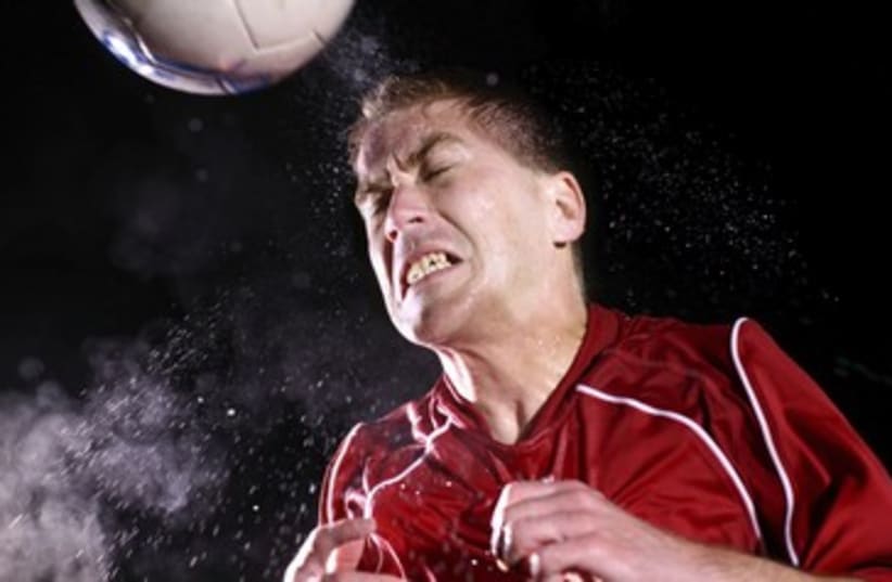 Soccer player hitting ball with head 390 (photo credit: Thinkstock/Imagebank)