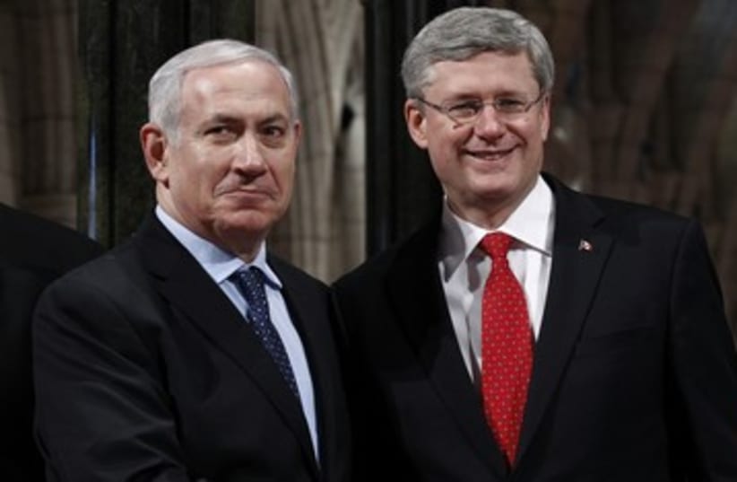 Netanyahu shakes hands with Candian counterpart R 390 (photo credit: REUTERS)