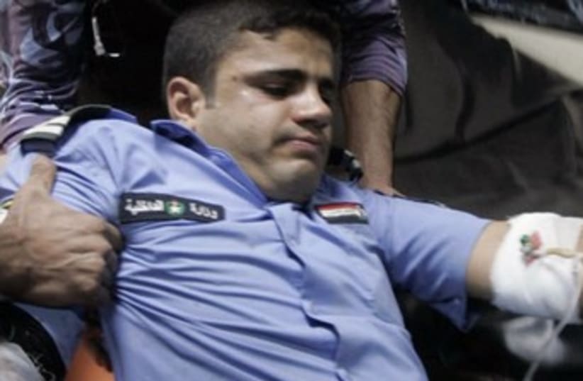 Injured Iraqi policeman 370 R (photo credit: Reuters/Ako Rasheed)