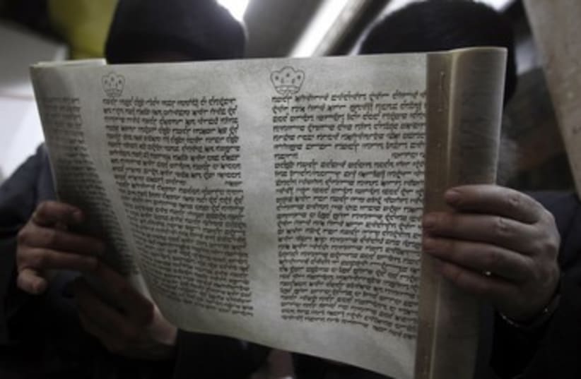 Ultra-Orthodox in Bnei Brak read the Megilla (photo credit: Reuters/Ronen Zvulun)