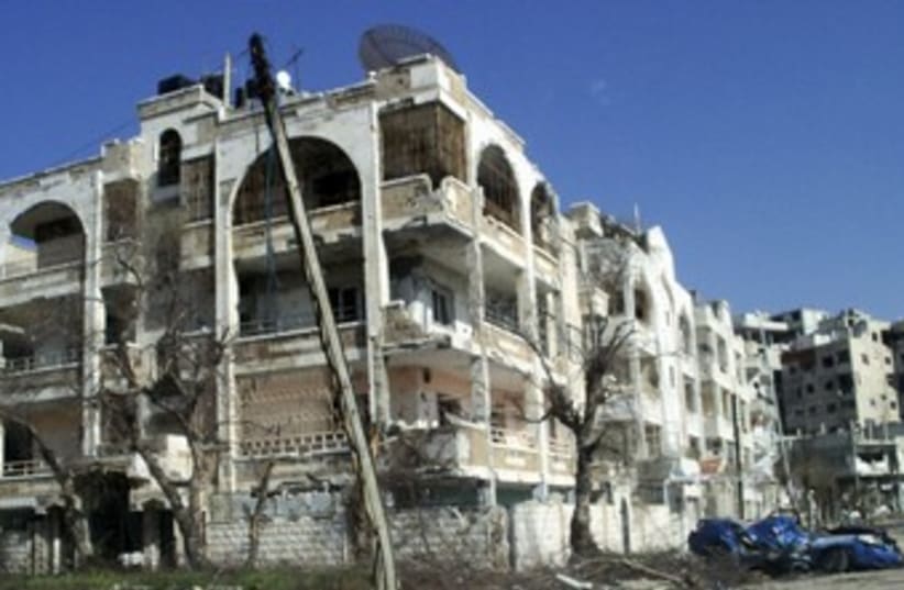 Damaged houses, vehicles in Homs, Syria_370 (photo credit: Reuters)
