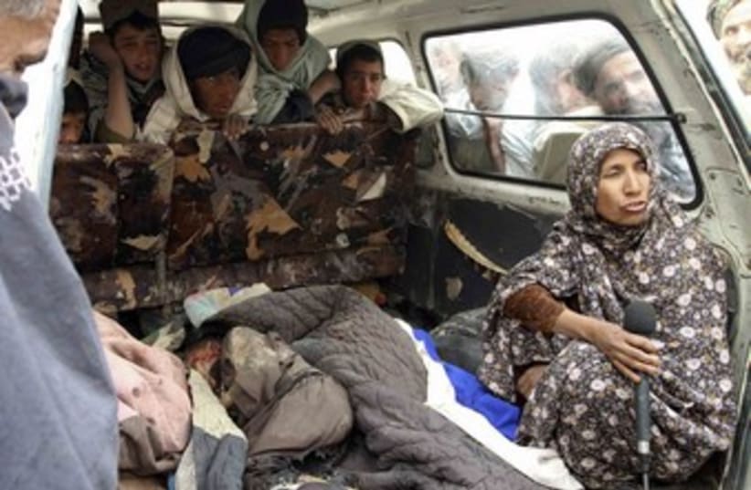 Afghan woman interviewed next to body of killed child_370 (photo credit: Ahmed Nadeem/Reuters)