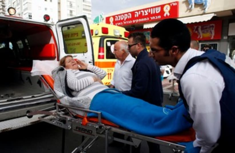 Israeli woman being evacuated to hospital 390 (photo credit: REUTERS/NIR ELIAS)